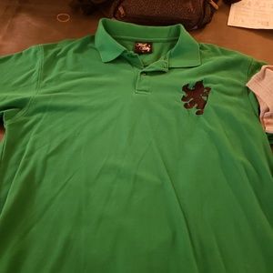 Green polo with a lion on the chest